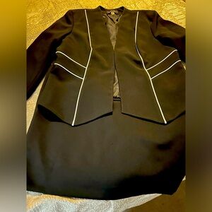 Women’s black Evan Picone suit with white accent lines on front of jacket